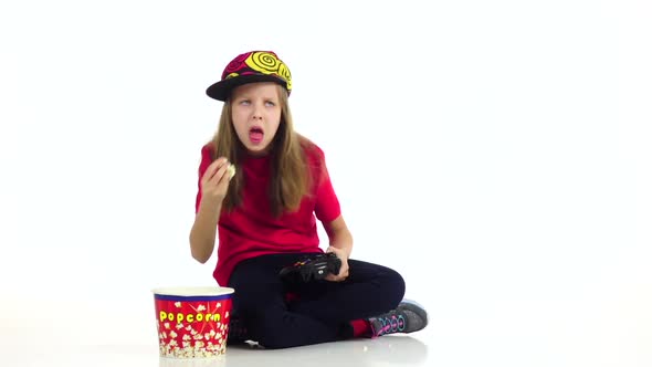 Girl Eats Popcorn, Plays Joystick in Online Game. Slow Motion