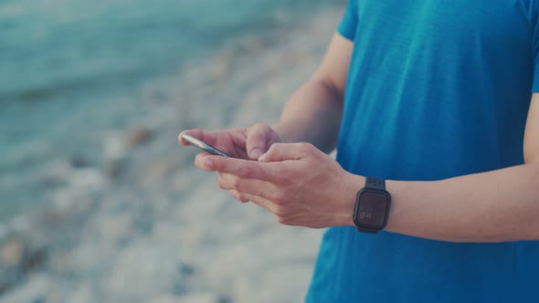 Close up hands typing a message on a smartphone.