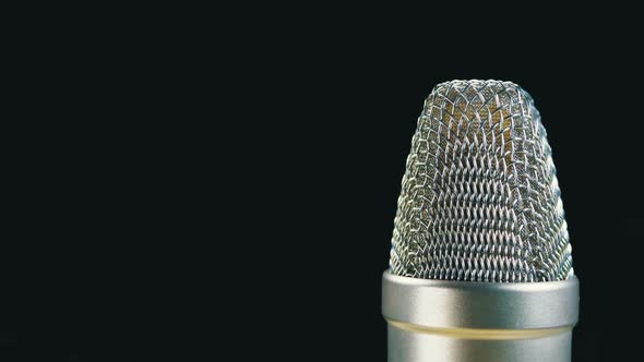 Studio Condenser Microphone Rotates on a Black Background