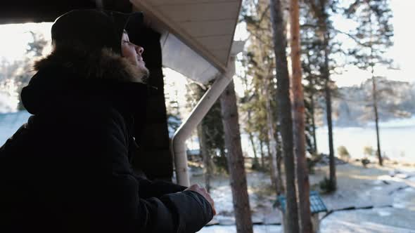 A Young Man on the Balcony Is Enjoying Nature