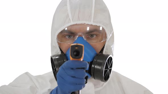 Doctor in Protective Biohazard Suit Points Laser Thermometer To Check Your Temperature at a Covid19