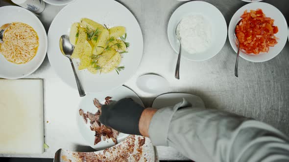 Fast Food Worker Serving and Seasoning Meat Pieces for Traditional Middle Eastern Kebab Dish