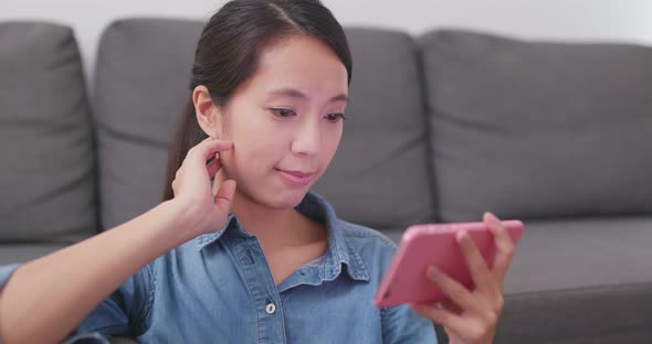 Woman watching on cellphone and feeling eye pain at home