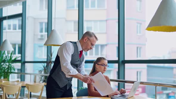 Mature entrepreneur with young secretary at work