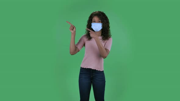 Portrait of Beautiful African American Young Woman in Medical Protective Face Mask Looking at Camera