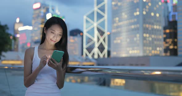 Woman using mobile phone at night 