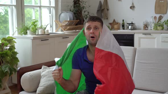 An Italian Male Football Fan Supports the National Team with the Flag of Italy