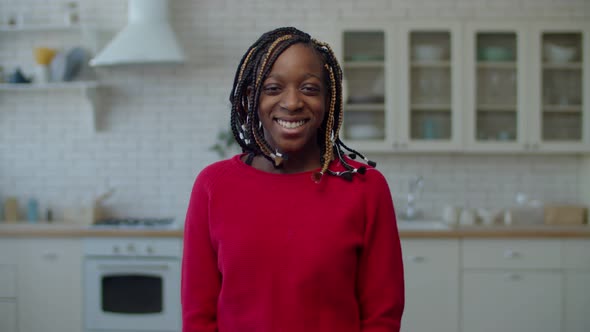 Cheerful Preadolescent Girl with Braids Smiling at Home