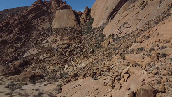 Aerial footage of a side of the rocky mount Erongo in Namibia, desert region