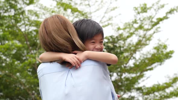 Asian Mother Carry Herson In The Park On Summer Day Slow Motion 