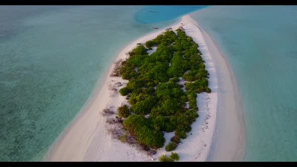 Aerial top down seascape of tropical lagoon beach journey by blue green water with white sandy backg