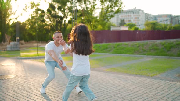 Daughter Runs to Dad and Hugs Him