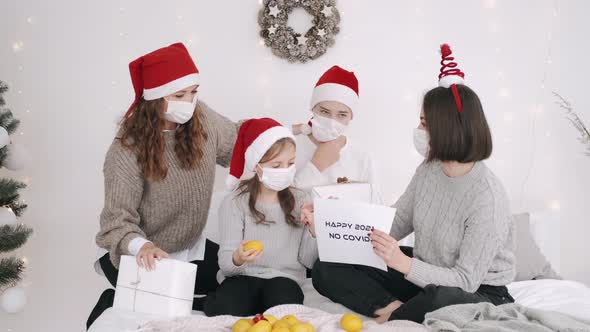 Festive Family in Party Hats and Masks Celebrating New Year