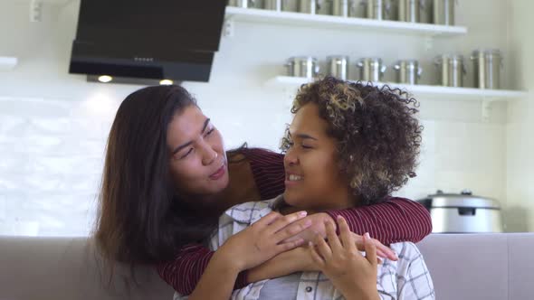 Girlfriend Asian Hugs Her AfricanAmerican Girlfriend From Behind