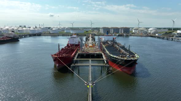 Crude Oil Tanker Ships Unloading Petrochemicals to a Shore Fuel Depot