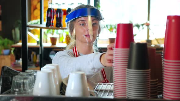 Barista in Face Shield Making Takeaway Coffee