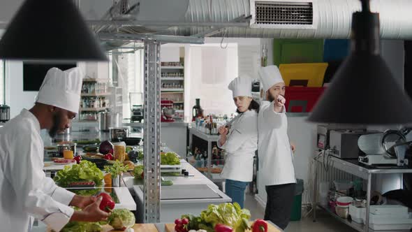 Man and Woman Cooks Acting Funny with Knives in Kitchen