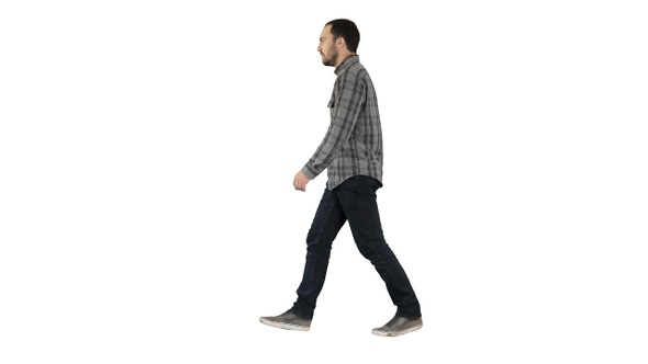 Young casual man walking on white background.