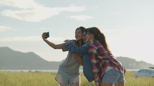 Group of a young Asian woman taking selfies having fun together a summer traveling.