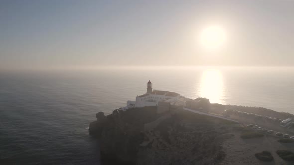 Bright hazy sun and vast expanse of ocean in Cabo de Sao Vicente lighthouse Sagres.