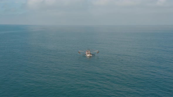 Small traditional Mexican boat in Pacific Ocean, fishermen and pelican