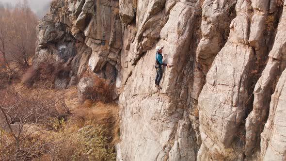 Man Athlette Climbing on the High Rock