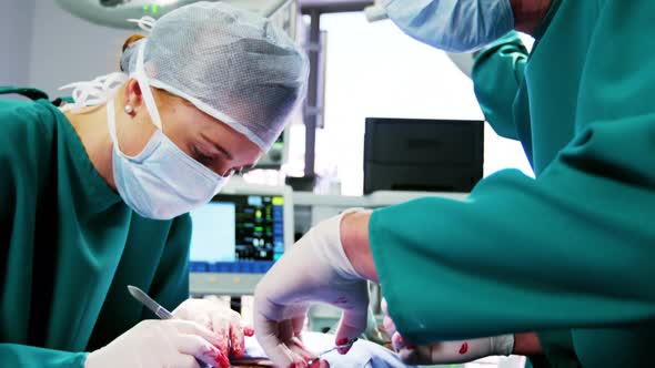 Surgeons performing operation in operation room