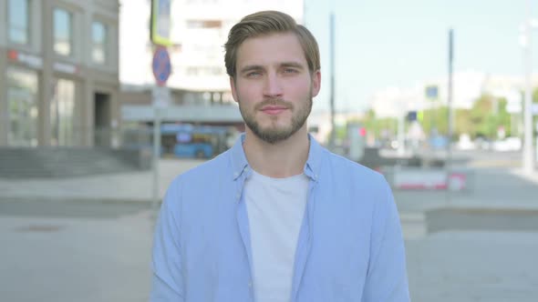 Portrait of Man Looking at the Camera Outdoor