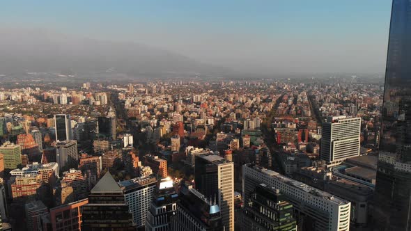 Aerial descending and revealing line of skyscrapers on financial district, Santiago, Chile