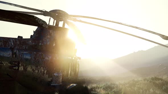 Old Rusted Military Helicopter in the Desert at Sunset