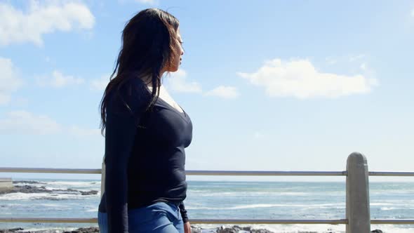 Side view of disabled woman walking on promenade near railing 4k