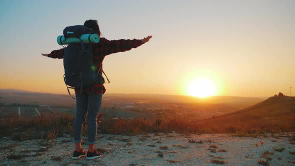 Successful Girl Hiker Open Arms in the Sky After Hiking To Mountain Top Summit Above the Clouds