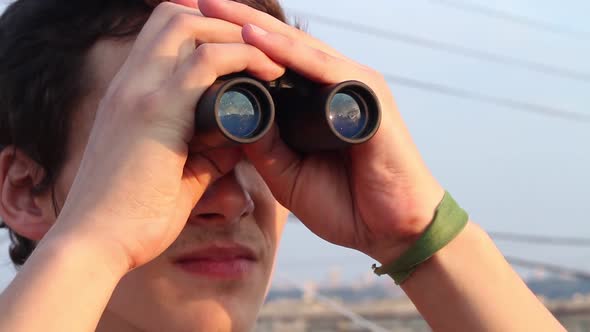 Man Looking Through Binoculars