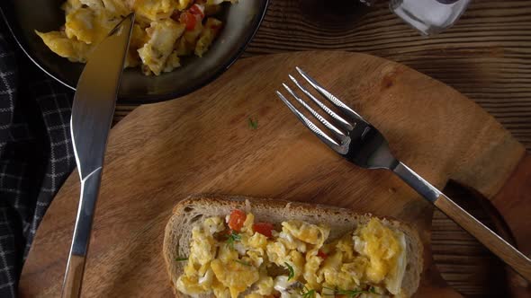 Scrambled eggs on a slice of bread.