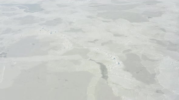 Ice Frozen in Waves As Seen From a Drone Flying Above the Surface