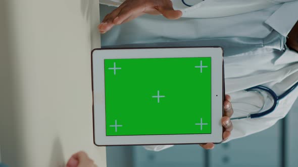 Vertical Video Physician Using Digital Tablet with Green Screen at Appointment