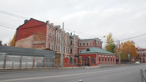 Old Building with Red Walls and Decor on Windows in Street