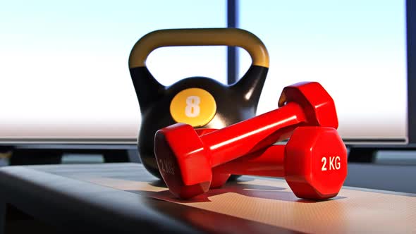 Fitness Equipment: Kettlebell, dumbbells and erobic step on a green yoga mat.