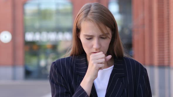 Sick Businesswoman Coughing while Standing Outdoor