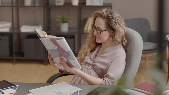 Expecting Woman Reading Maternity Book