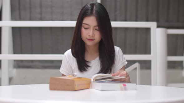 Young undergraduate girl do homework, read textbook, study hard for knowledge and education