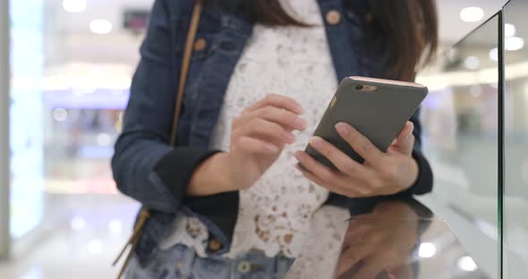 Woman use of mobile phone in shopping mall