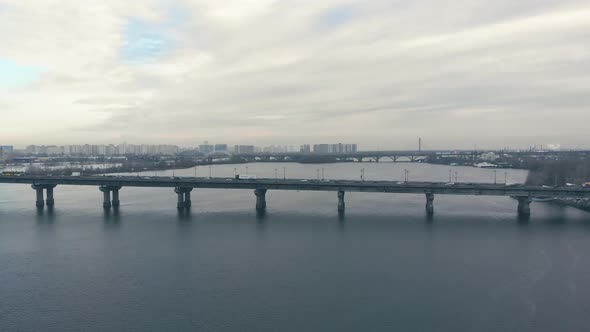 Traffic on a Bridge Over a Wide River in the Winter