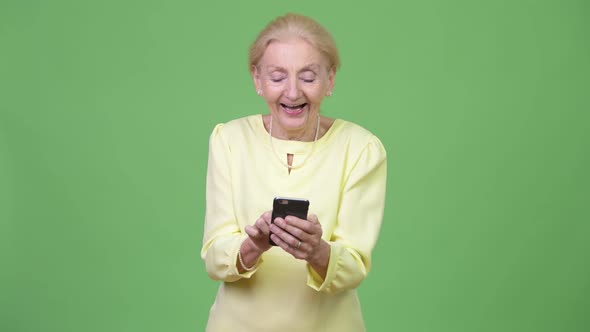 Beautiful Happy Senior Businesswoman Using Phone