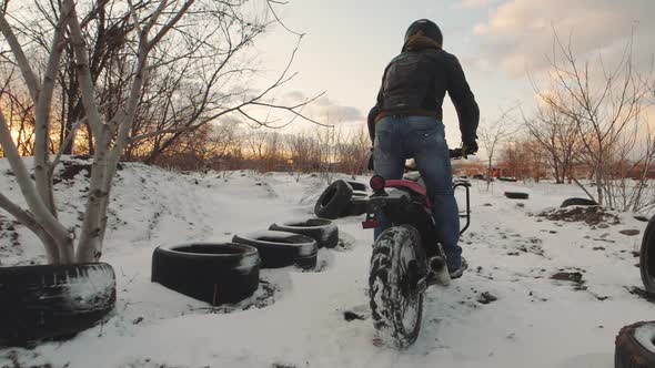 Biker Ride on Bike in the Snow Field Slow Motion