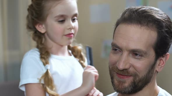 Caring Daughter Combing Father Hair and Kissing Cheek, Family Love, Parenthood