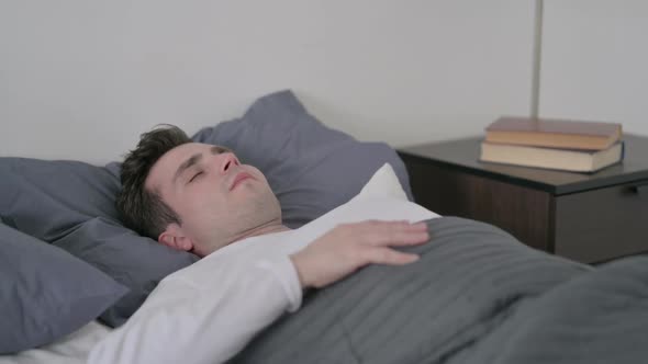 Man Coughing While Sleeping in Bed