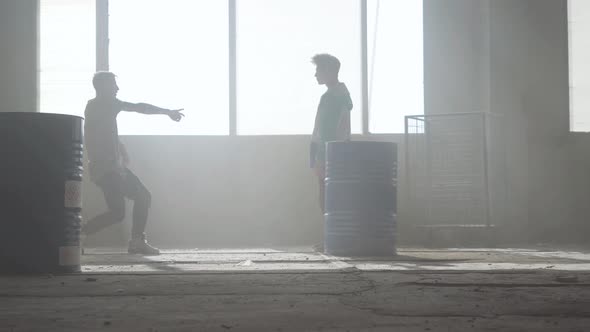 Dance Battle of Two Street Dancers in an Abandoned Building Near the Barrel