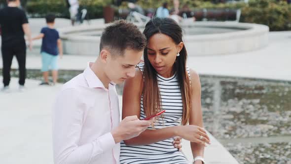 African Young Woman is Upset Because of Her Boyfriend Looking in the Smartphone All the Time