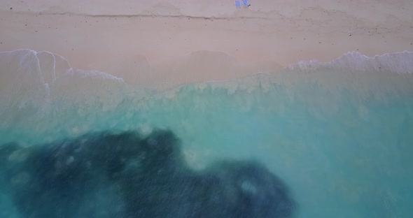 Luxury aerial copy space shot of a paradise sunny white sand beach and turquoise sea background in h